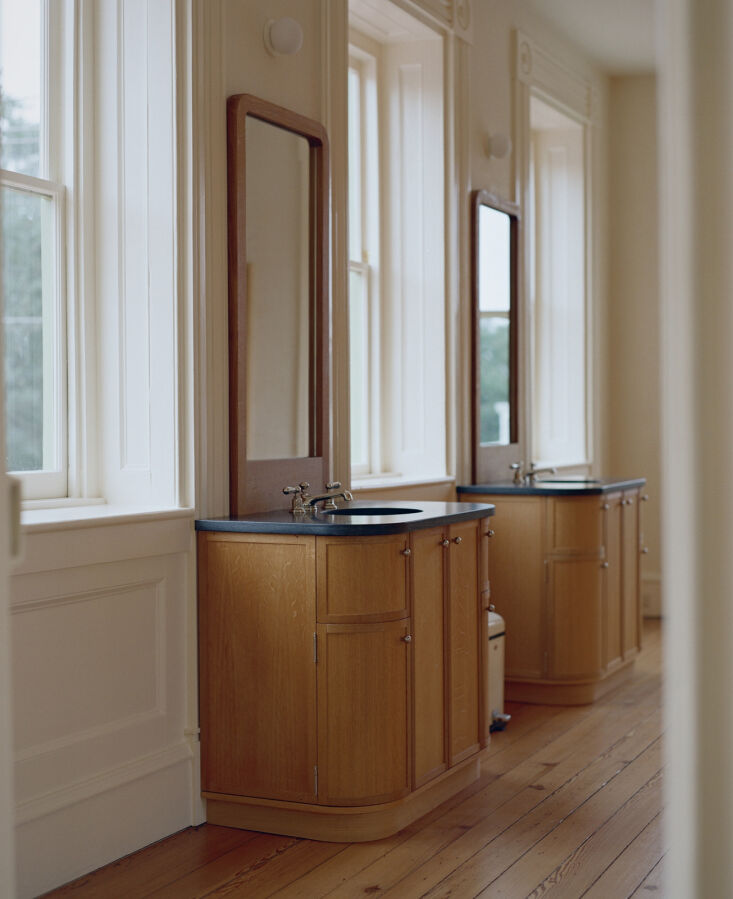 Modern custom double sinks with elegant metallic faucets and hardware.