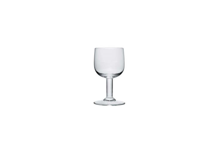 Set of four minimalist glass goblets on a plain background.