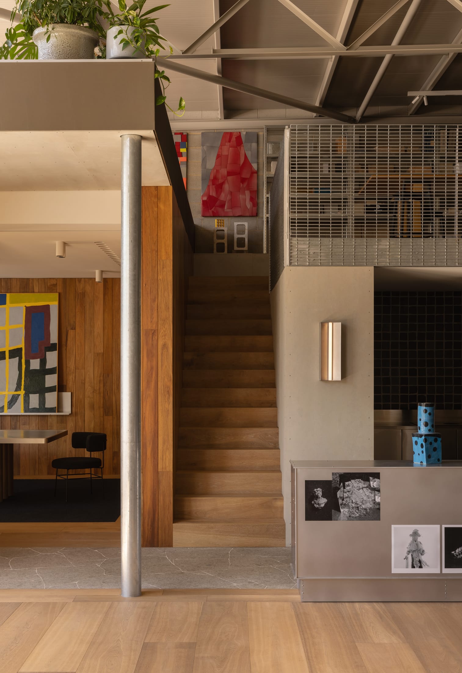 Detailed shot of curated artwork and bespoke furniture within the studio space.