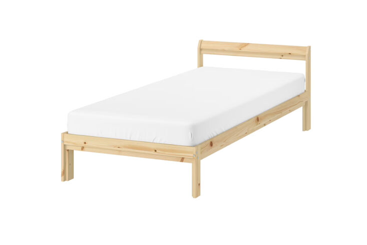 A simple IKEA Neiden pine bed frame against a minimalist attic wall.