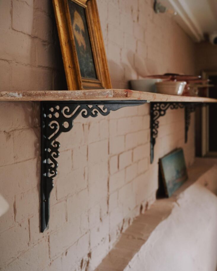 Heavy-duty cast iron scullery shelf brackets with matching screws.