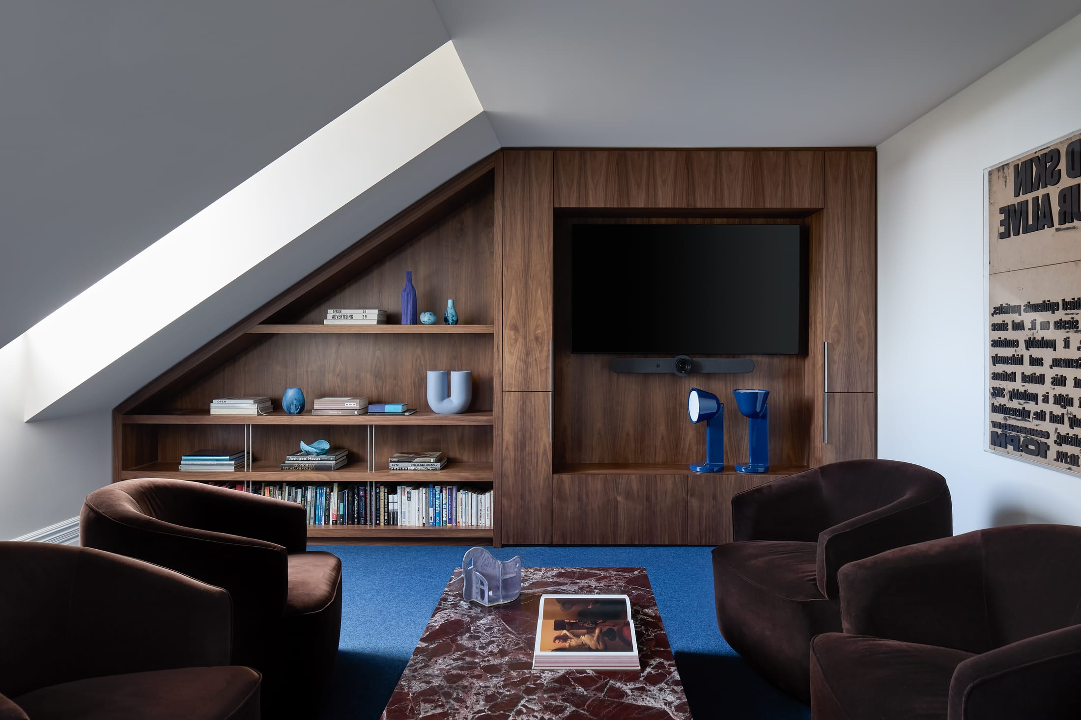 Interior view of curved timber-clad workstations and shelving reflecting the building's exterior geometry.