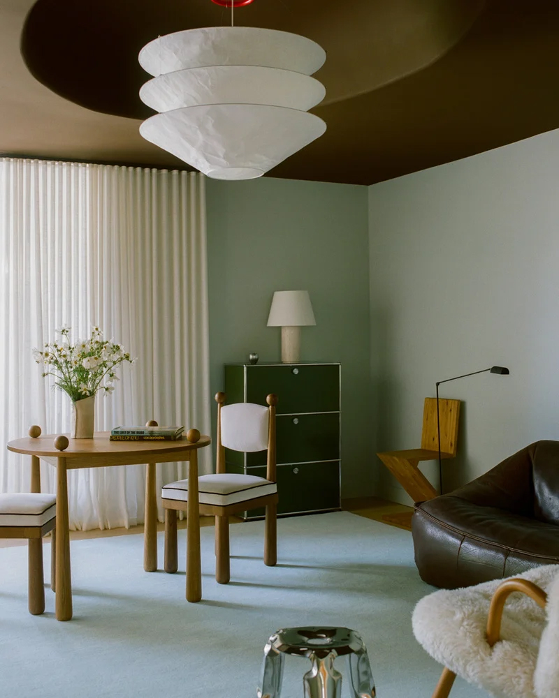 The Nordic Knots Grand Rug in powder blue placed in a minimalist room.