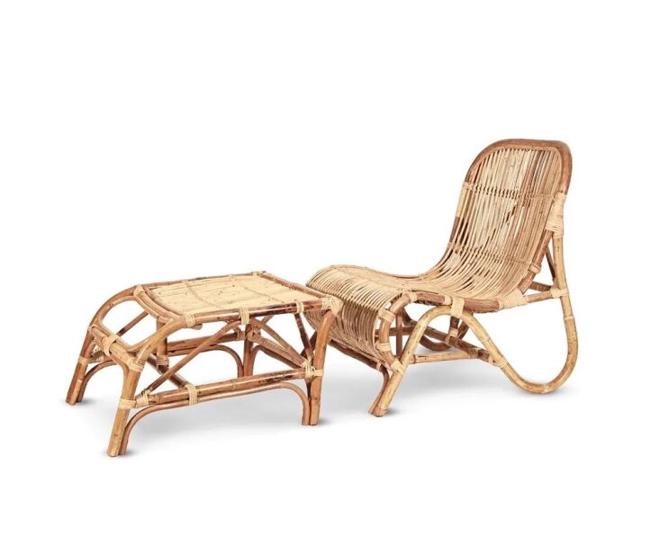 A Rattan Kim Lounge Chair with an ottoman on a clean background.
