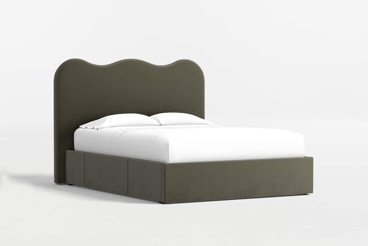 The Amara Curved Upholstered Storage Bed with a stylish wavy headboard and upholstered drawer fronts.