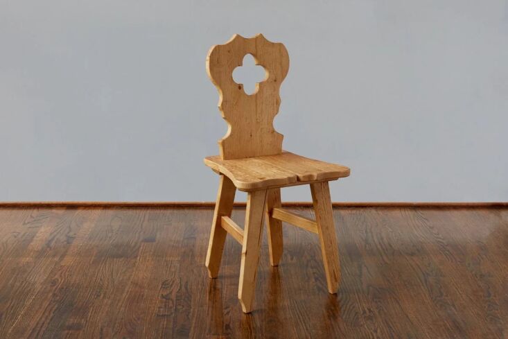 A new Tyrolean Chair in natural pine featuring a decorative clover cut-out on the backrest.
