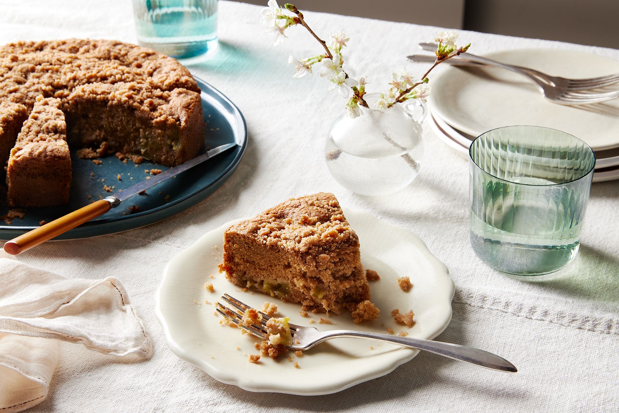 A close-up shot of a slice of green tomato crumb cake showing its moist texture and spiced topping.