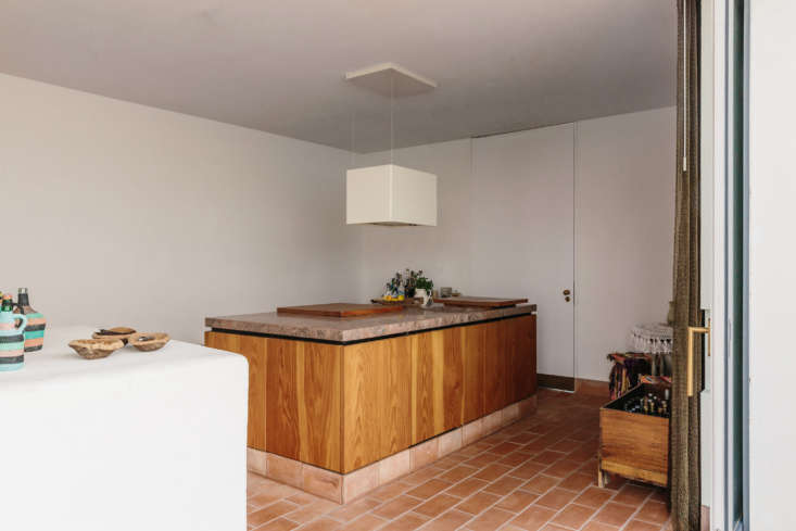 Kitchen interior with a Douglas fir island and Brecha Algarvia stone countertops.