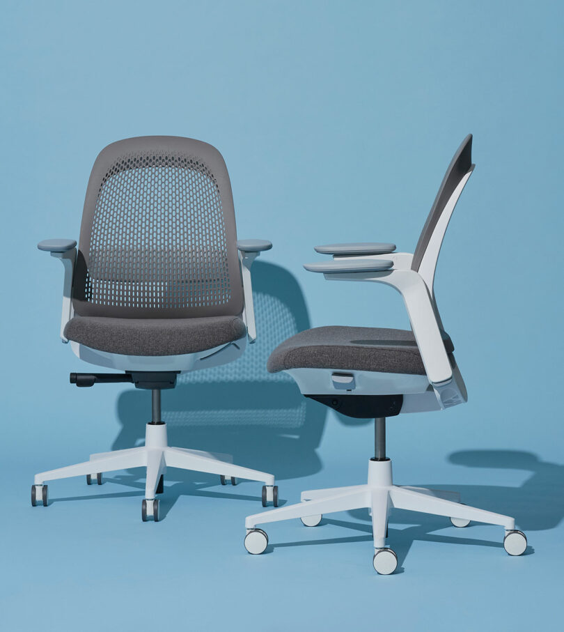 Two Haworth Breck chairs in white and gray frames side-by-side on a light blue background.