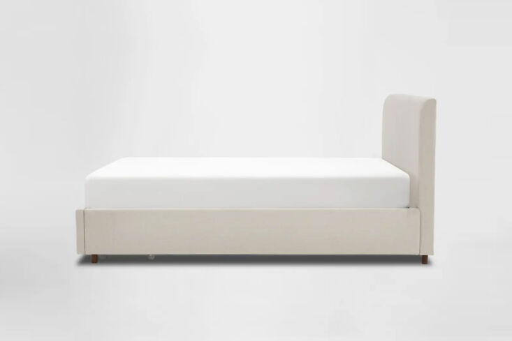 A close-up of the Silk and Snow bed frame showing the seamless integration of its under-bed storage drawers.