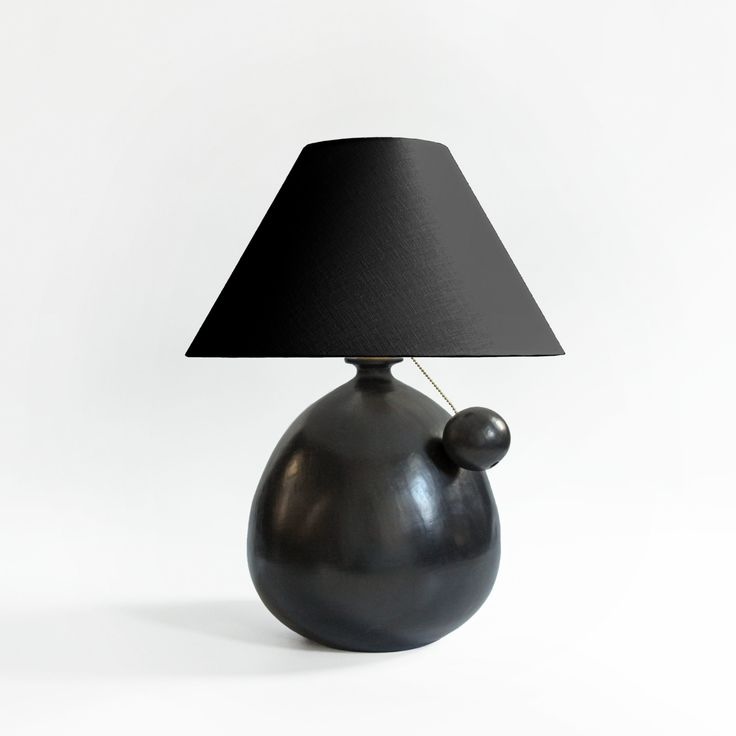 A matte black ceramic lamp made from Barro Negro clay.