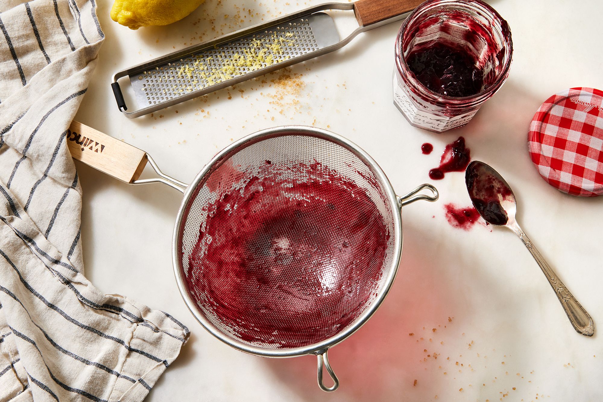 A collection of complex kitchen tools that are difficult to clean, including food processor parts.