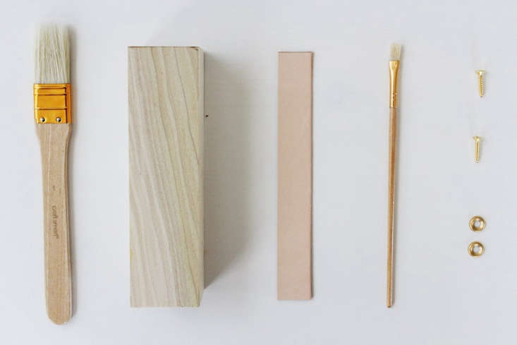 Raw reclaimed wood blocks and basic woodworking tools on a work surface.