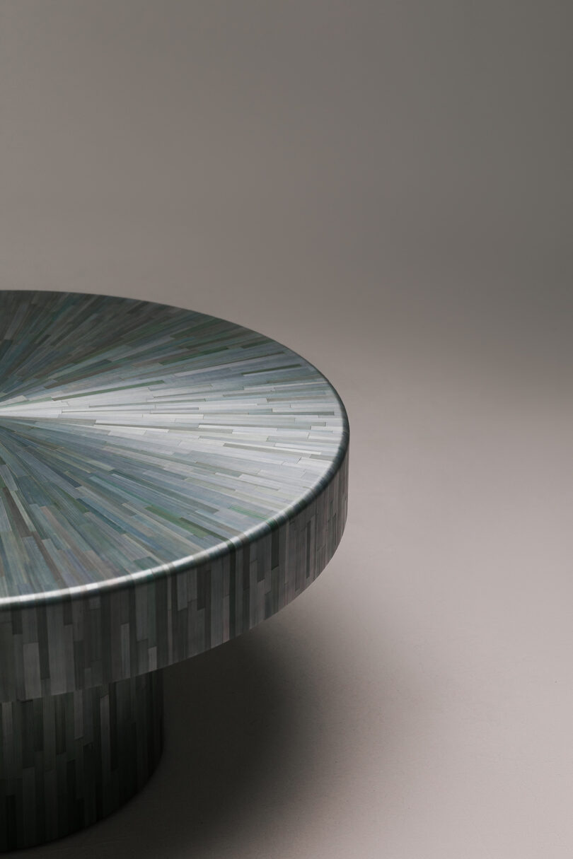 Macro view of the table surface showing the natural variations in blue-gray and green straw tiles.