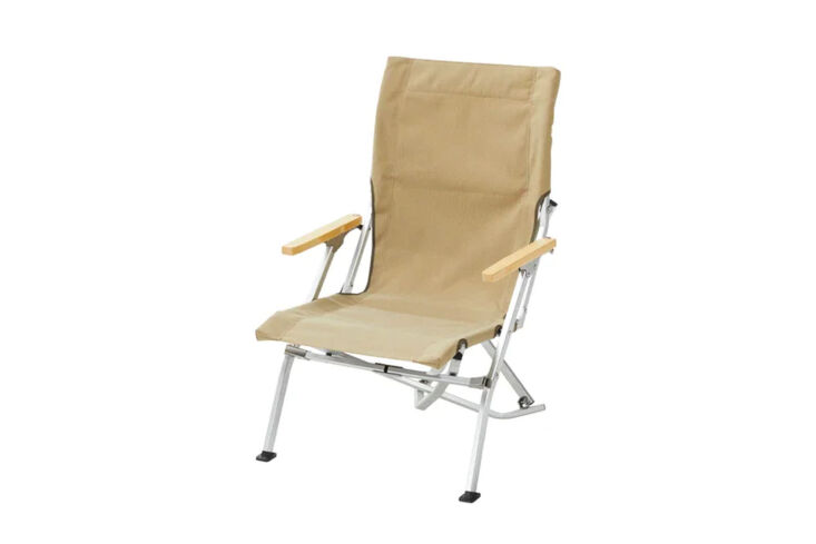 Low-profile camp chair with natural wood armrests and a durable canvas seat.