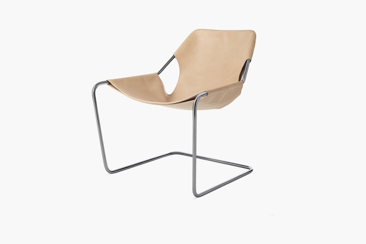 The Paulistano Armchair featuring a continuous carbon steel frame and a cognac leather sling.