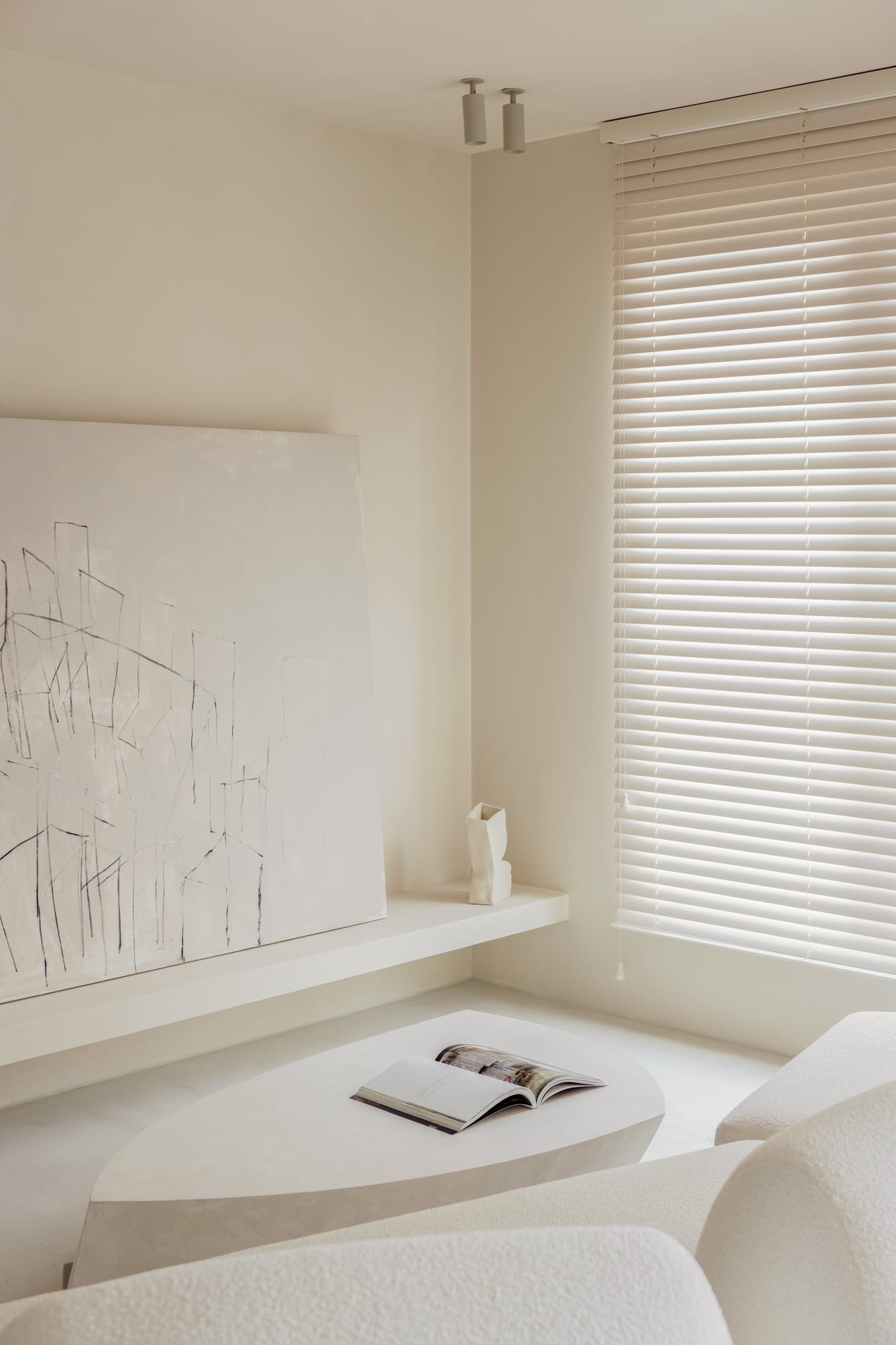 Close-up of matte white walls and textured stone surfaces in the apartment.