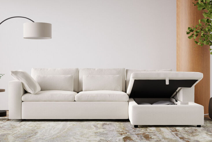 A high-end West Elm Harmony modular sectional in a neutral fabric with a long storage chaise.