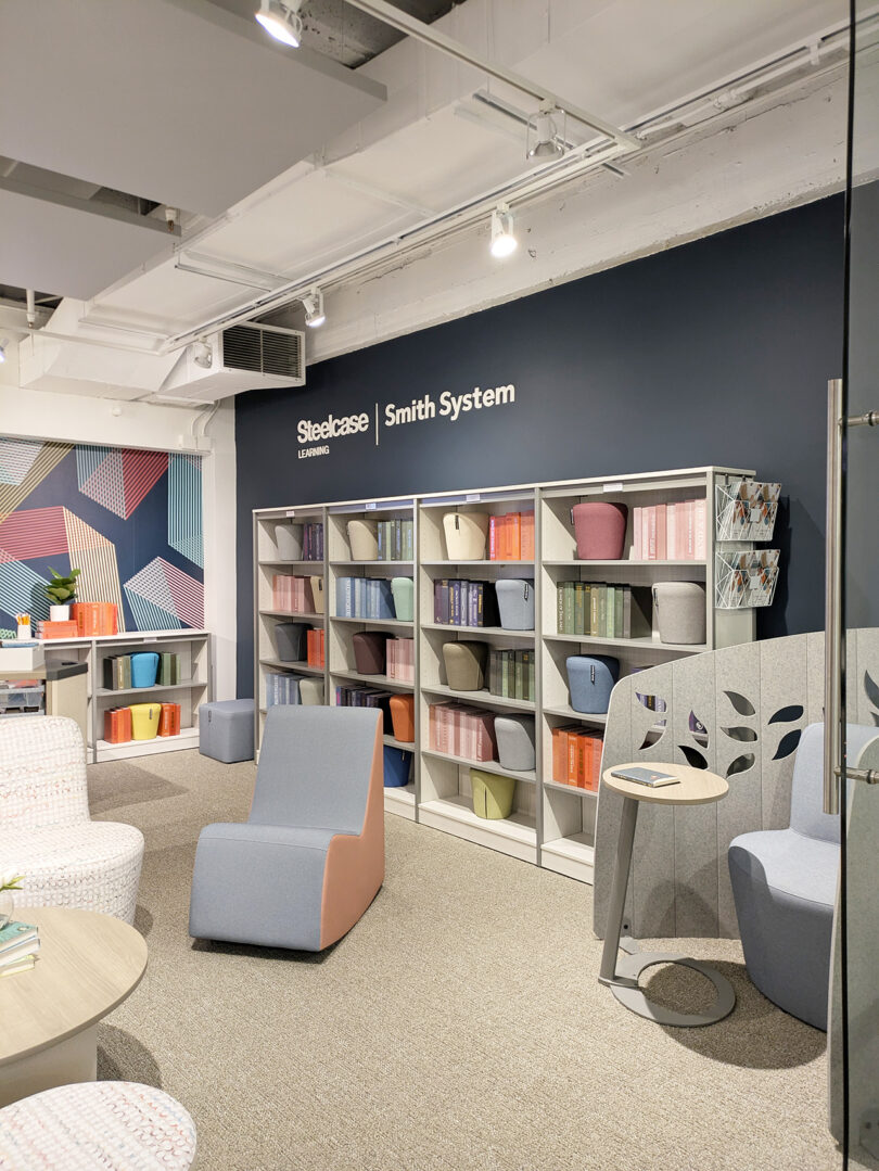 A bright educational space with colorful books and modular seating labeled Steelcase Smith System.