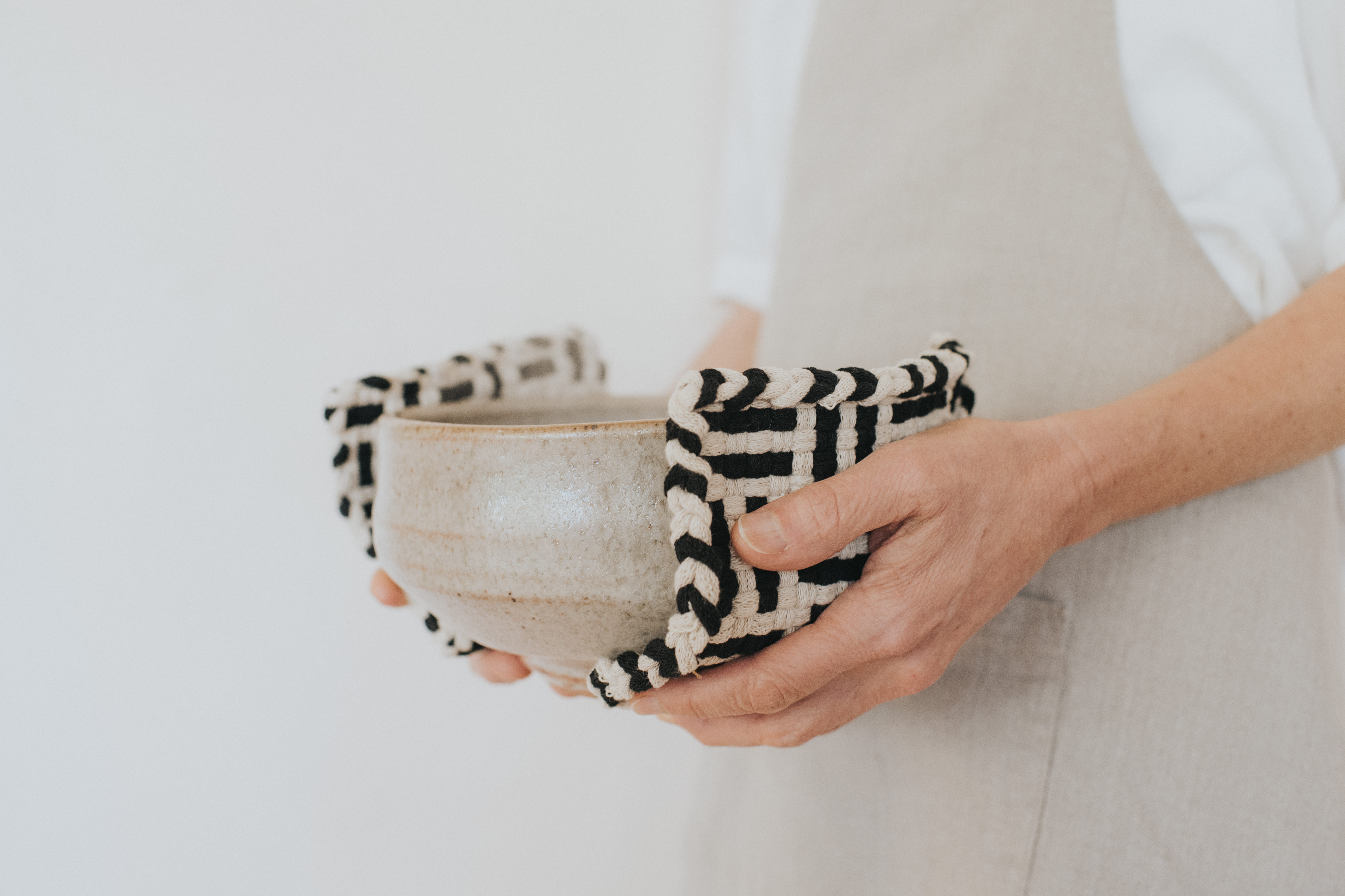 Classic hand-woven potholders showing the traditional square weave pattern.