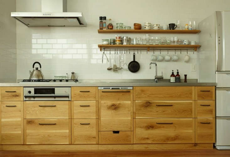 Close-up of light oak cabinetry showing natural wood grain and knots.