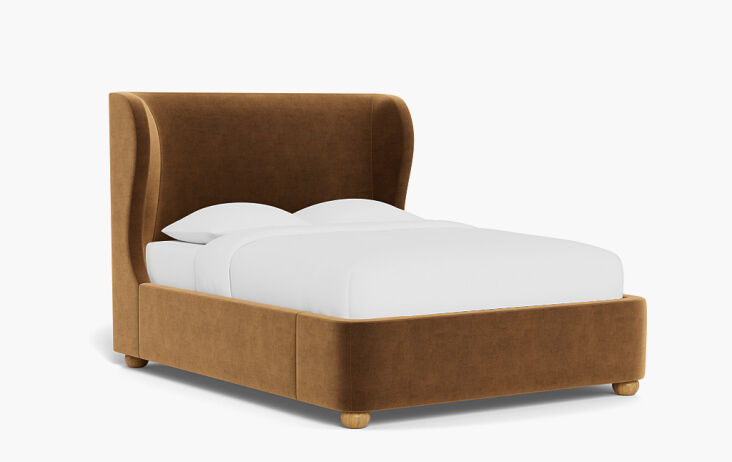 A luxury lift-up upholstered bed with the mattress raised to reveal a large storage compartment beneath.