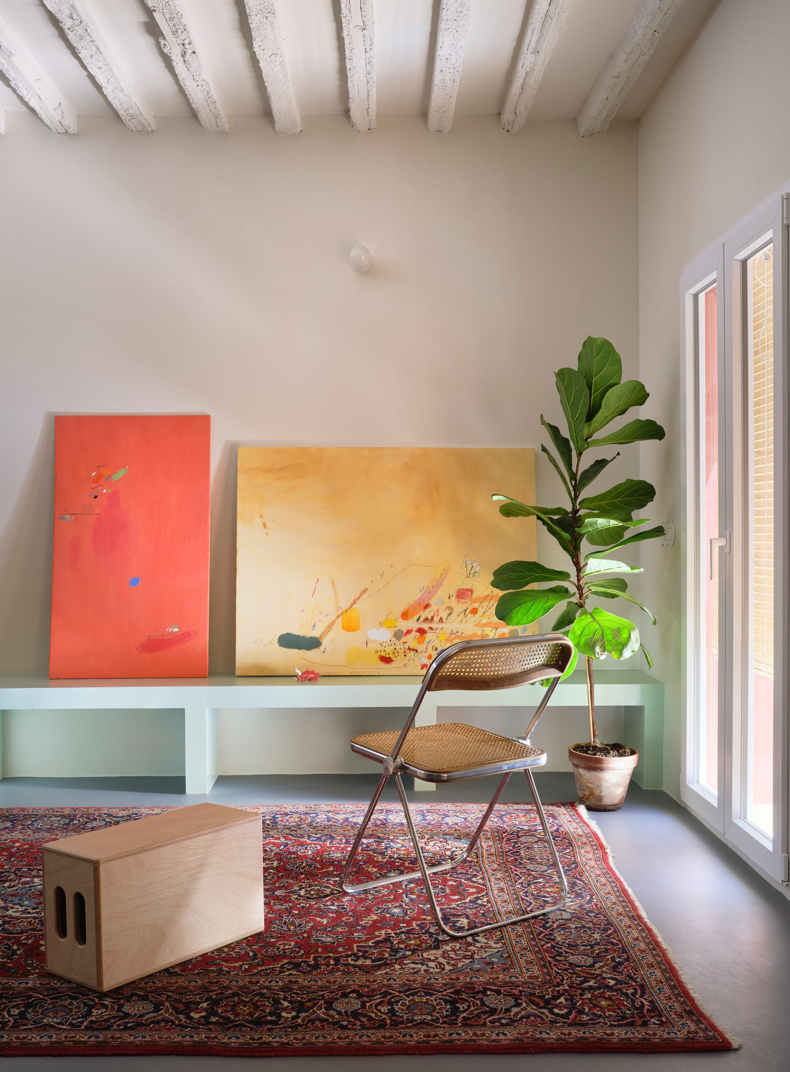Interior shot of the green kitchen and stairs integrating seamlessly into the living space.