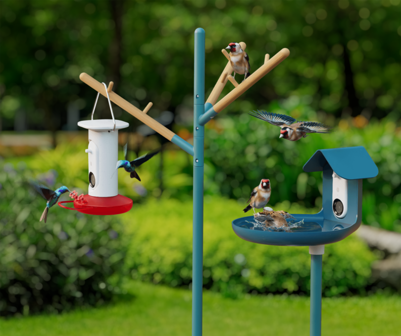 The Bird Buddy smart hummingbird feeder and smart birdbath positioned in a sunlit garden.