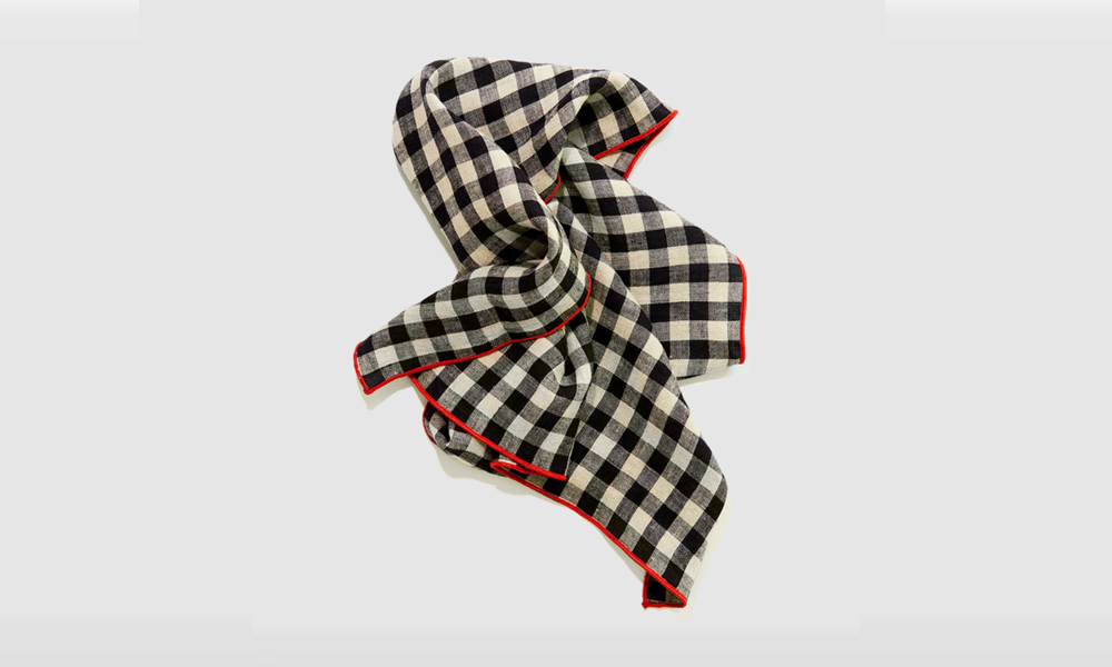 A Legume-colored napkin with a black and white contrast edge.