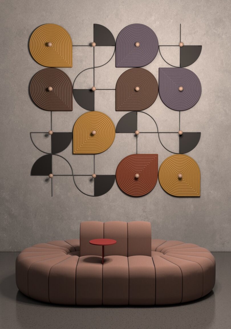 Circular beige sofa with a small red table integrated into the center.