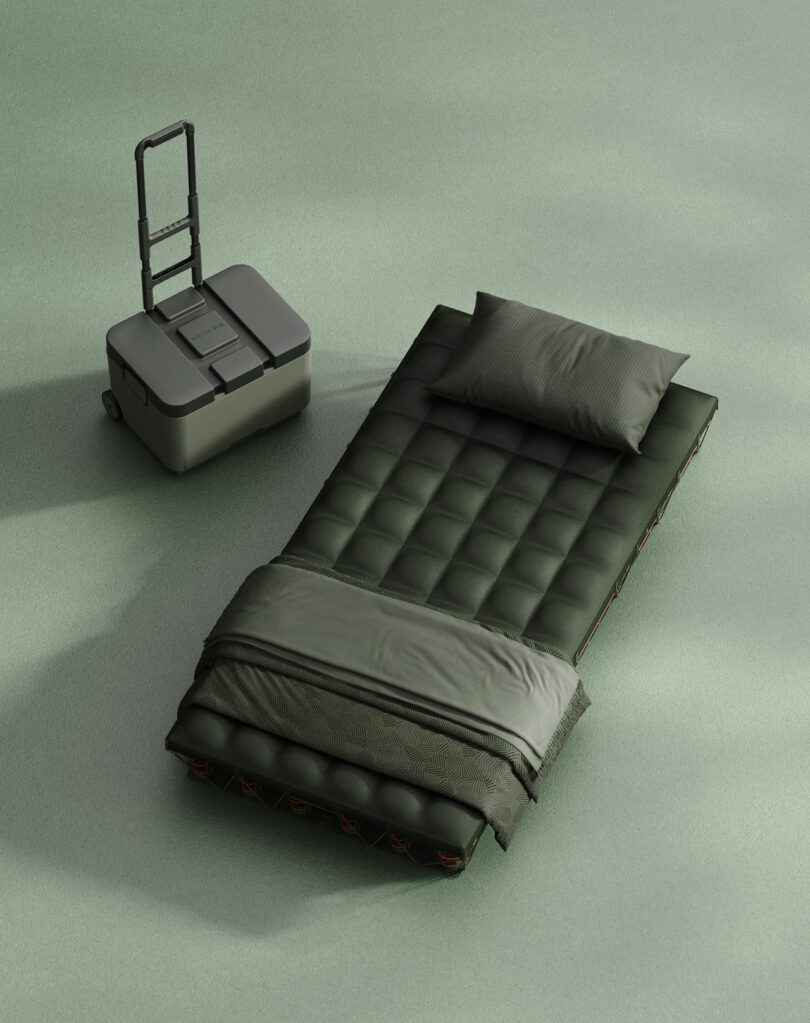 A fully assembled green MAZZU mattress with a pillow and blanket next to a modular storage case.