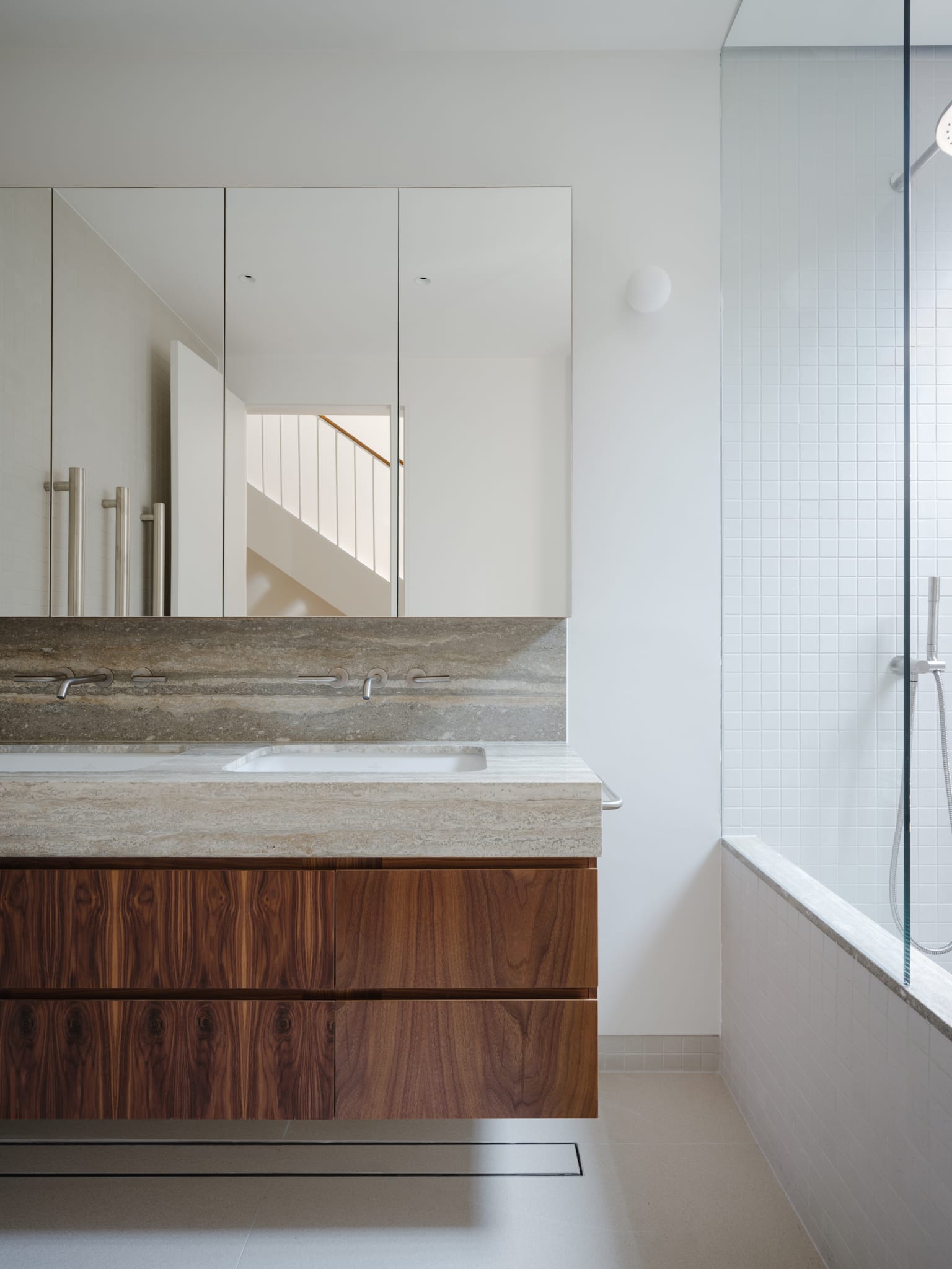 A minimalist bedroom within a narrow house layout showing efficient use of space.