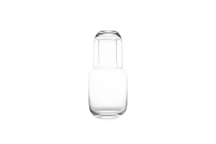A trio of Toyo Sasaki glass night carafes in clear, amber, and smoke grey.