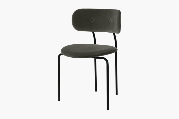 The Gubi Coco Dining Chair with Dove grey upholstery and a minimalist black frame.