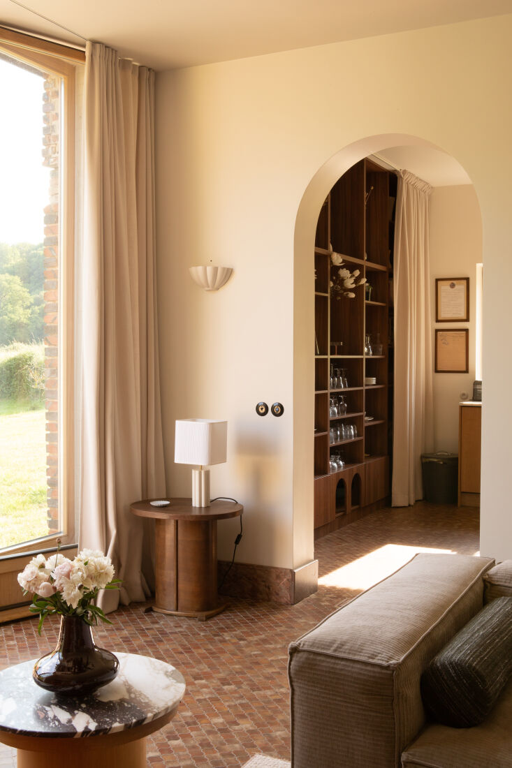 Interior shot of Le Moulin showing brick floors and elegant white archways.