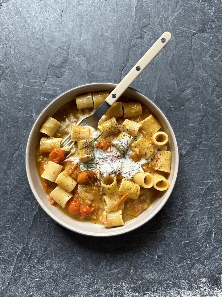 Rigatoni pasta tossed with bright yellow sungold tomatoes, fennel, and fresh herbs.