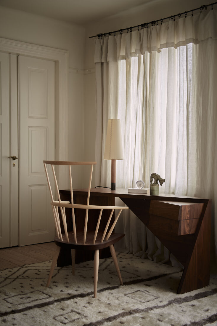Santa & Cole Básica lamp positioned on a minimalist writing desk in a Gothenburg home.
