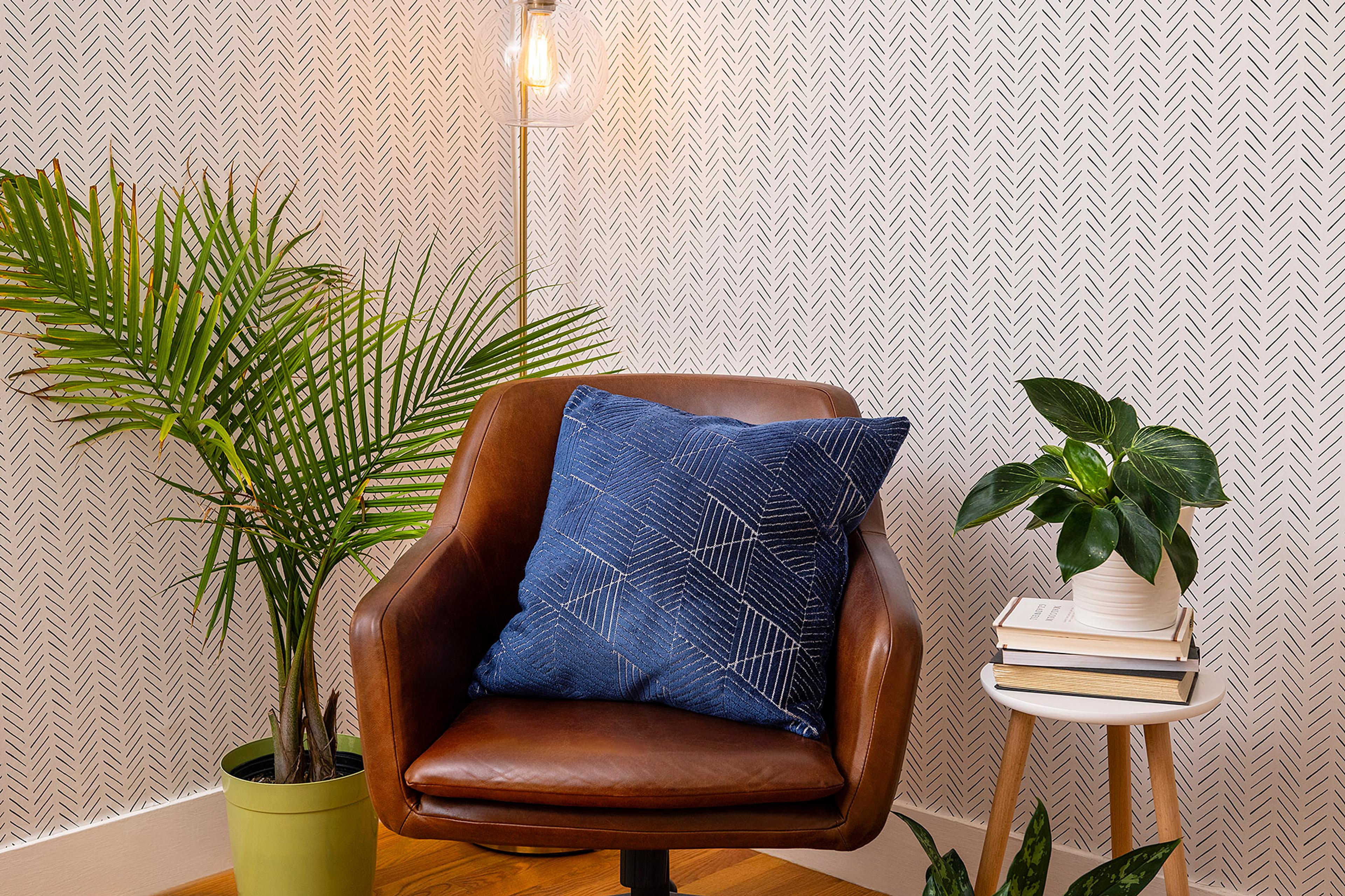 A comfortable corner chair paired with a standing floor lamp.