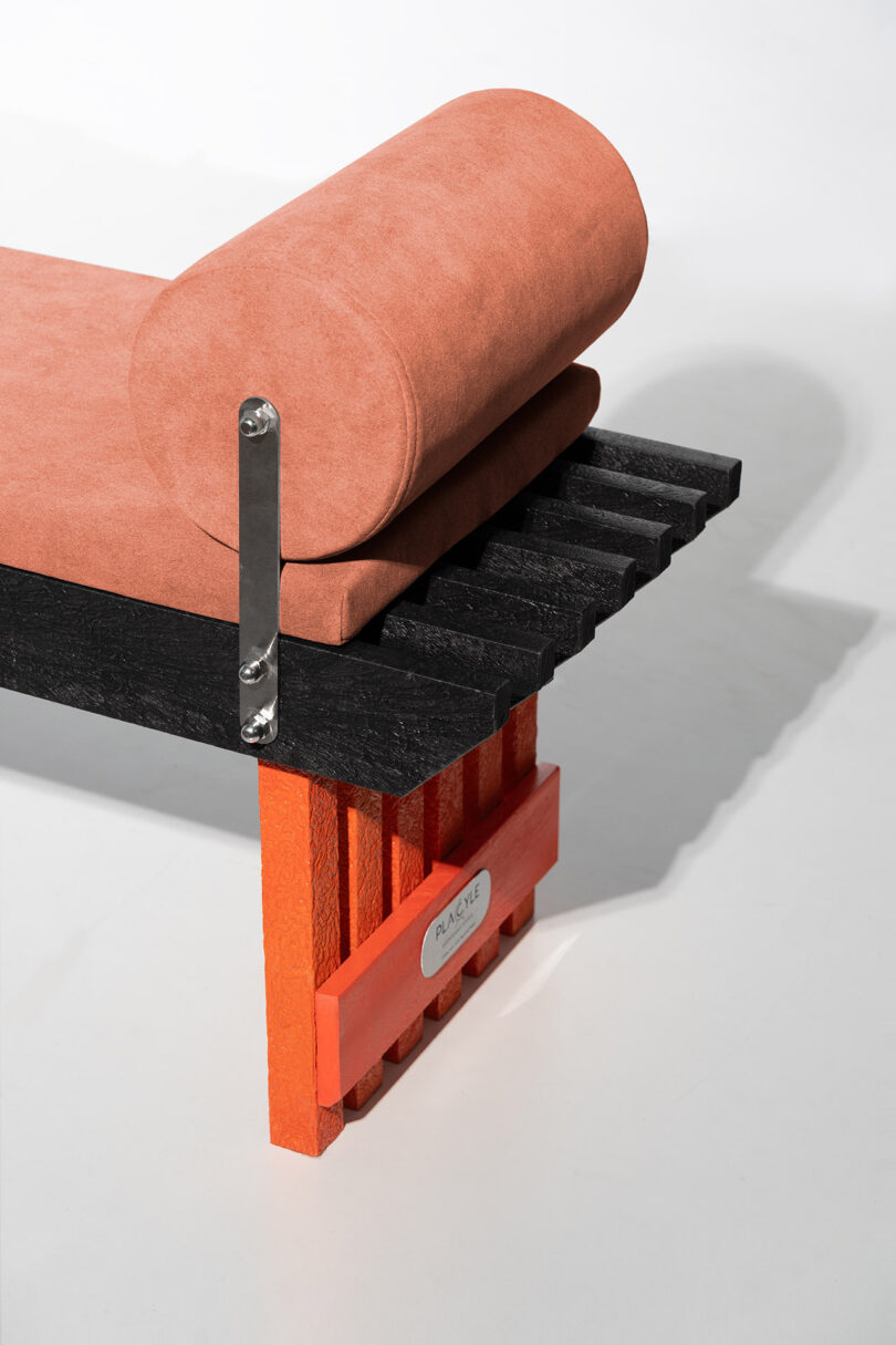 A Torii bench configured with a seat cushion and a cylindrical bolster pillow.