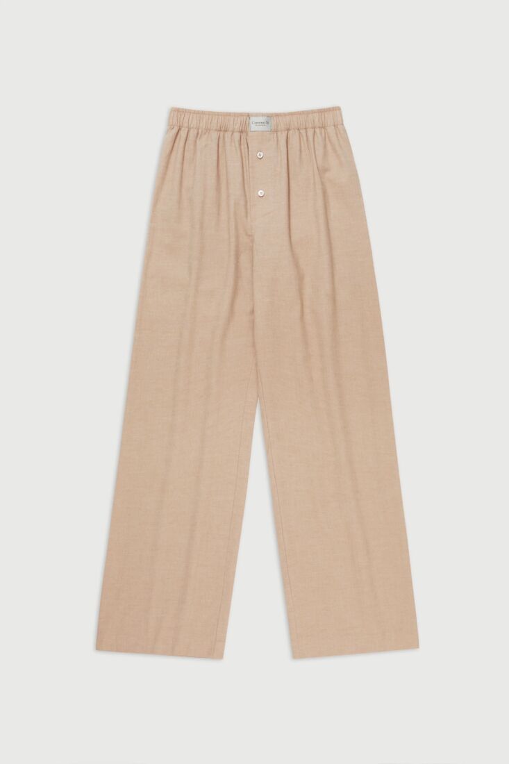 A close-up of striped blue and white cotton flannel pajama pants styled for all-day lounging.