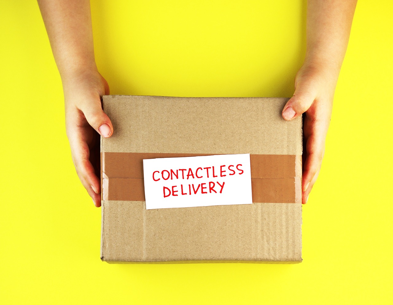 Large furniture delivery box arriving at a modern home entrance