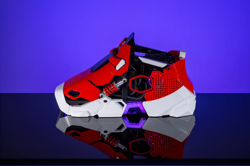 A side view of the Sneaker X PC against a blue-purple gradient background.