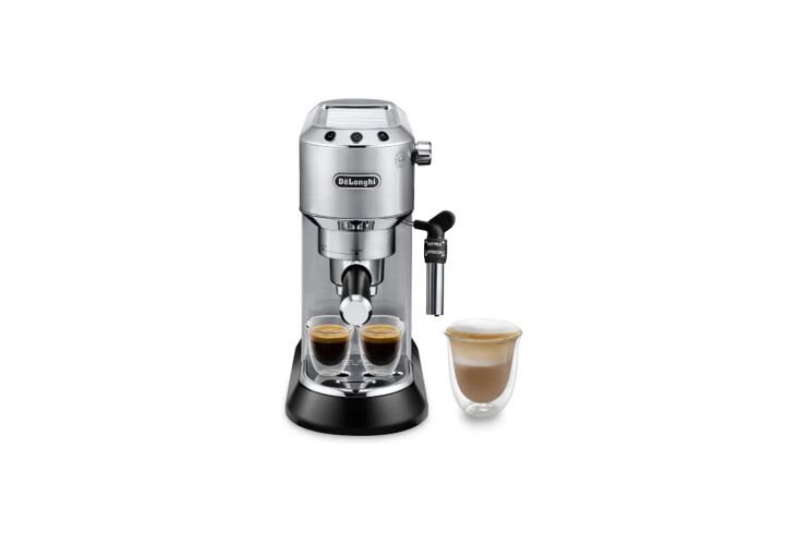 A slim, stainless steel DeLonghi Dedica Deluxe Espresso Machine on a kitchen counter.