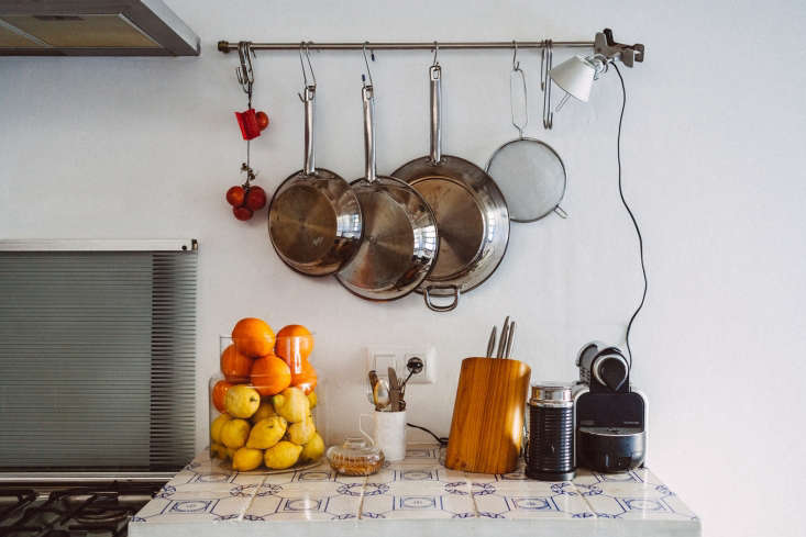 An IKEA Grundtal rail with a clip light mounted over blue and white patterned Menorcan tiles.