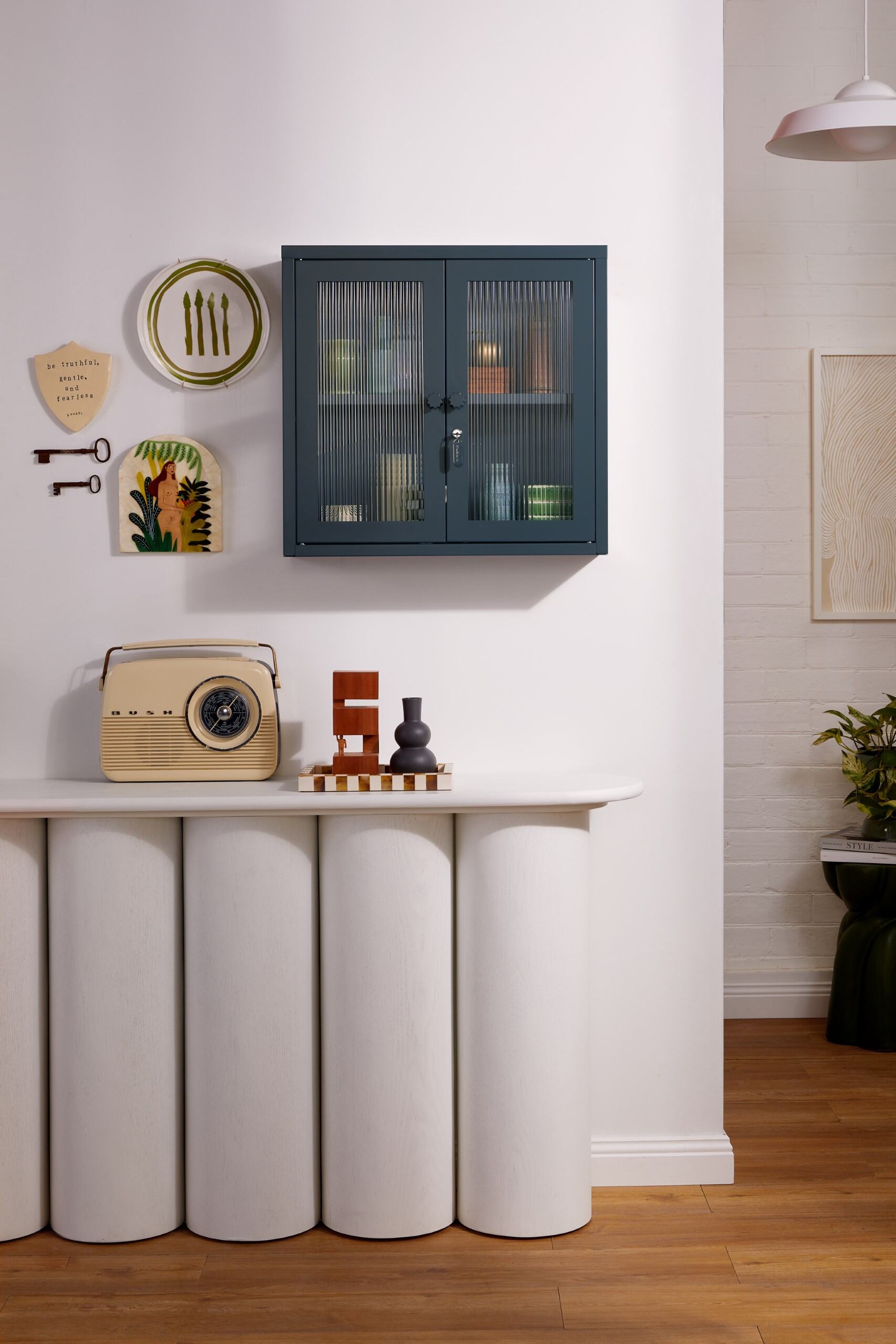 The Kit in Slate, a small wall-mounted or tabletop glass-fronted metal cabinet.