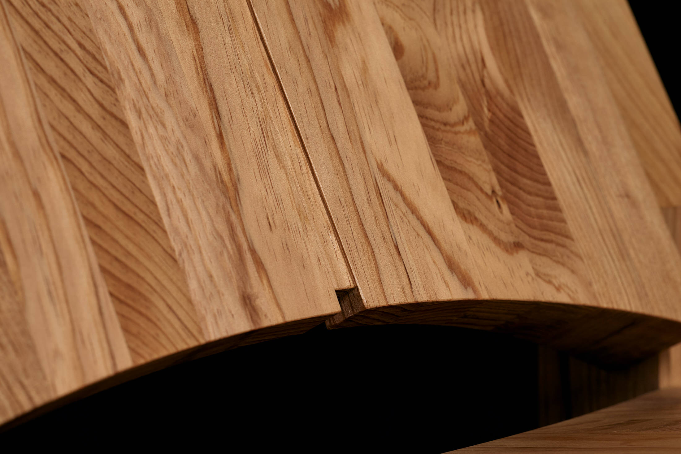 Side profile of the Knot Pine chair highlighting its structural lines and clean joinery.