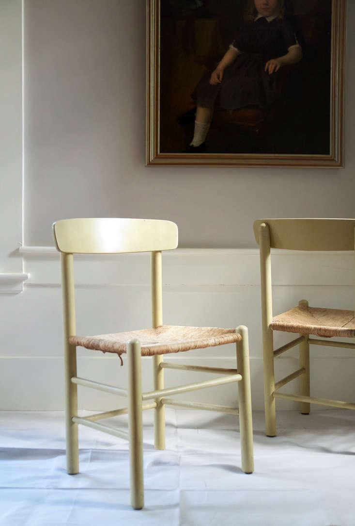 Two vintage wooden chairs with dated, dark finishes before restoration.