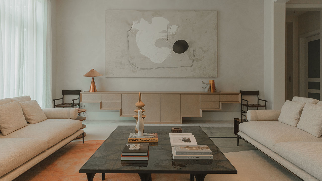 A modern living space showcasing material restraint and neutral-toned furniture.