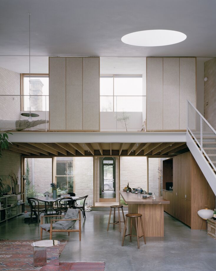 Interior view showing Japanese-inspired sliding screens in a loft space with a Noguchi lamp.