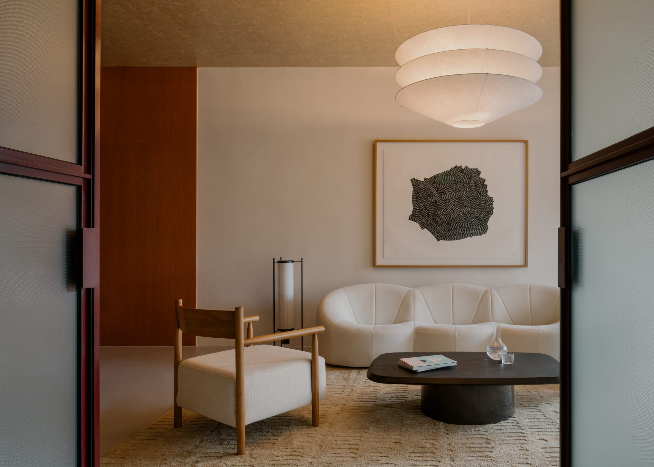 Office lounge area featuring terracotta-colored seating and earth-toned furniture.